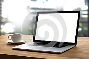 Laptop with blank screen on table interior, man at his workplace