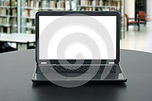 Laptop with blank screen on the table in library