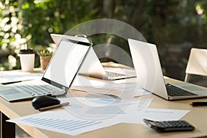 Laptop with blank white desktop screen on table with computer no