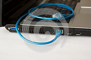 Laptop and blue networking cable