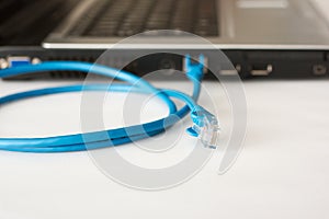 Laptop and blue networking cable