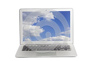Laptop with blue sky and white clouds on screen