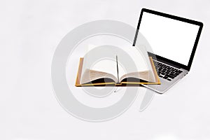 Laptop and book isolated on white background.