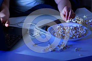 Laptop and bowl of popcorn