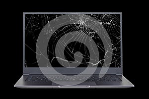 laptop with a broken  cracked screen isolated on black background close up