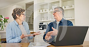 Laptop, budget and stress with a senior couple in their home together, talking about accounting or finance. Tax, debt or