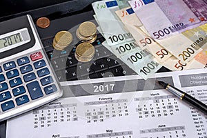 laptop, calendar and euro bills