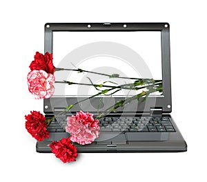 Laptop with carnations bouquet