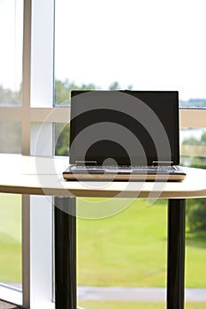 Laptop with clipping path in modern office.