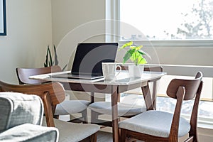 Laptop and coffee cup on a table in stylish modern apartment