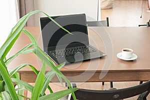 Laptop with coffee cup wooden table.