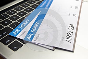 Laptop computer and Air tickets on table. Online ticket booking concept
