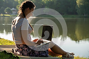 Laptop, computer business technology. Student girl working on tablet in summer nature park. People person outdoor. Woman