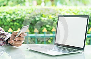 Laptop computer and cup of coffee on the outdoor table