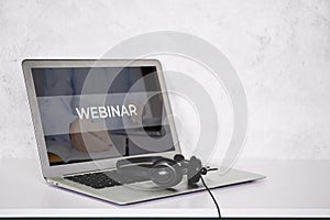 Laptop computer and headphone on desk, e-learning online, webinar for education and learning.