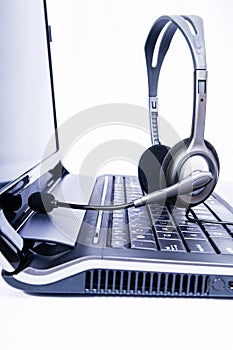 Laptop computer with headset on keyboard