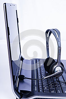 Laptop computer with headset on keyboard