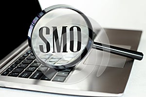 Laptop computer with magnifying glass, concept of search. SMO social media optimization photo