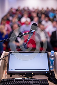 Laptop computer and microphone at podium