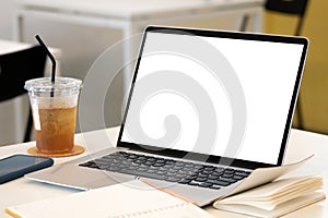 Laptop computer with mockup or blank screen on white desk in workspace and copy space concept