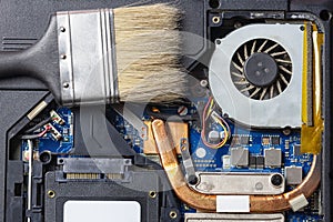 Laptop computer motherboard dust cleaning. cpu cooler system with dust and web.