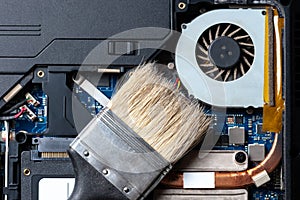 Laptop computer motherboard dust cleaning. cpu cooler system with dust and web. electronics maintenance at service