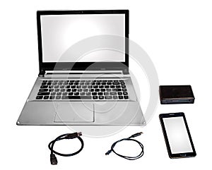 Laptop computer smart phone card reader and data cables chord isolated in white.