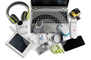 Laptop computer with smartphone and camera and ebook reader and other obsolete electronic gadgets on white background,Top view,