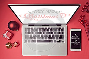 Laptop computer and smartphone with Christmas decorations. Christmas mock up template. View from above