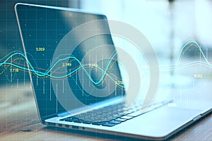 Laptop computer with stock chart and financial analytics