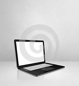 Laptop computer on white concrete office scene background
