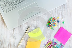 Laptop Computer On White Wood Desk With Push Pins Paper Clips an