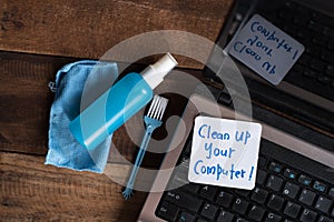 Laptop Computer on wooden table with note CLEAN UP YOUR COMPUTER