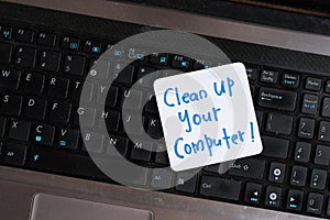 Laptop Computer on wooden table with note CLEAN UP YOUR COMPUTER