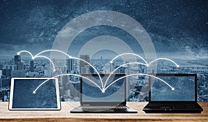 Laptop computers with network connection and sharing data to other devices. Internet networking and connection photo