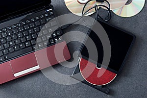 Laptop with connected portable optical drive.