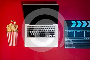 Laptop, credit card, clapper board, popcorn. Movies and cinema c