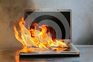 Laptop Damage. Laptop on fire and flames. Computer Repair. Flaming Fire laptop computer