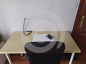 A laptop on a desk ready to telecommute