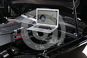 Laptop with diagram on auto engine. Car diagnostic