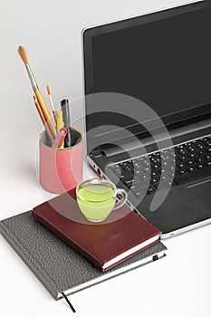 Laptop and Diary with cup of green tea. work from home concept
