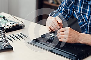 Laptop disassembling in repair shop, close-up