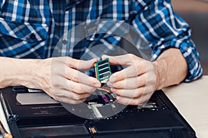 Laptop disassembling in repair shop, close-up