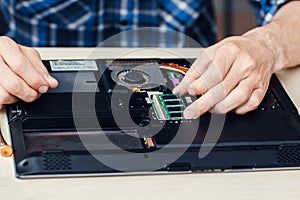 Laptop disassembling in repair shop, close-up