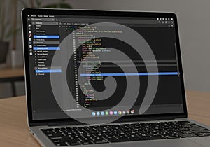 A laptop displaying a code editor