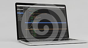 Laptop displaying a code editor with a dark theme, highlighting colorful syntax. The