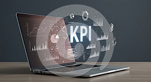 Laptop displaying digital analytics with graphs and charts. The display features