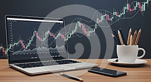 A laptop displaying a financial chart with candlestick patterns and moving averages photo