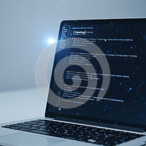 A laptop displays computer code on a black screen with colorful syntax highlighting in