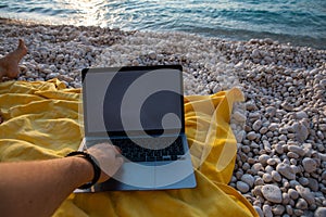 laptop with empty screen at sea beach freelance concept
